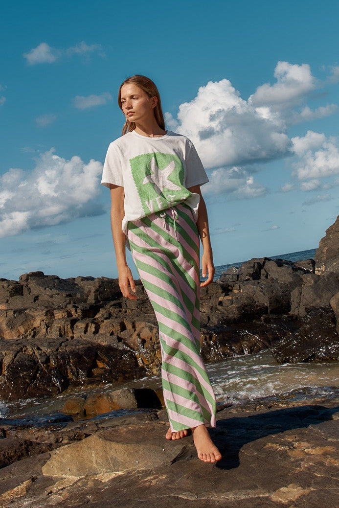 Image of a model wearing Skirts. Product name - Brooke Bias Skirt Green/Pink Stripe in Green/Pink Stripe colour by brand - Betty Basics