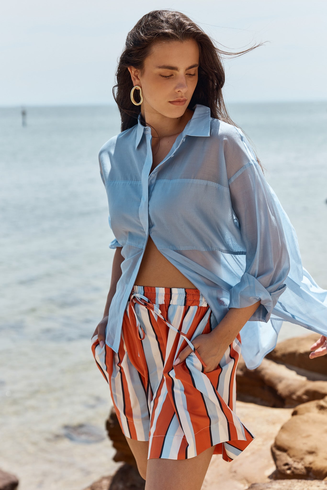 Image of a model wearing Tops. Product name - Val Oversized Shirt in Pale Blue colour by brand - Sass Clothing