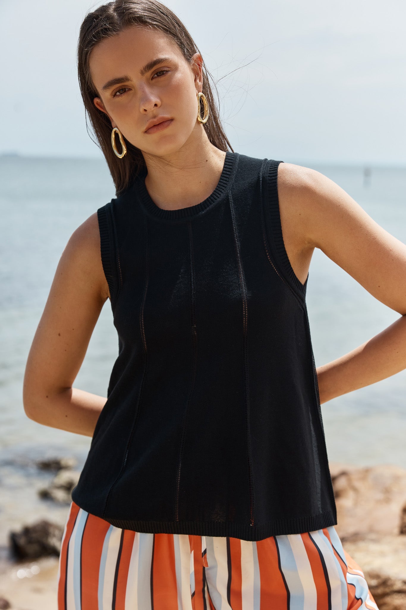Image of a model wearing Tops. Product name - Krista Pointelle Tank in Black colour by brand - Sass Clothing