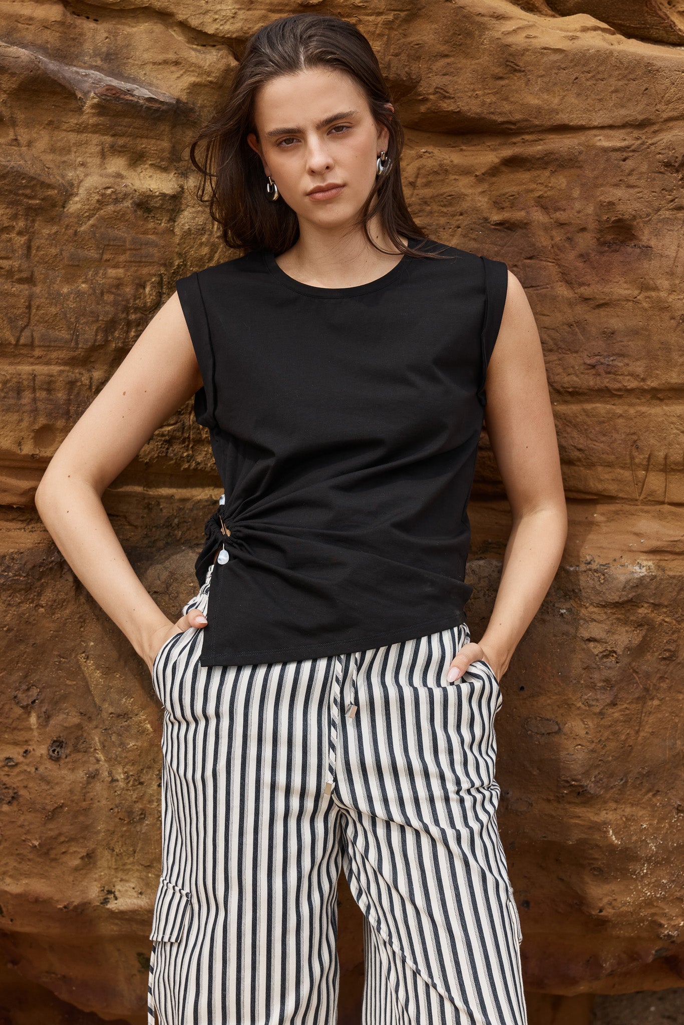 Image of a model wearing Tops. Product name - Dianna Stone Trim Tank Black in Black colour by brand - Sass Clothing