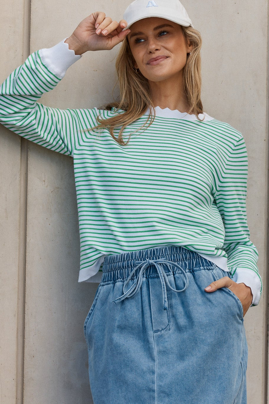 Image of a model wearing Outerwear. Product name - Scallop Knit Sweater Green Stripe in Green Stripe colour by brand - Betty Basics