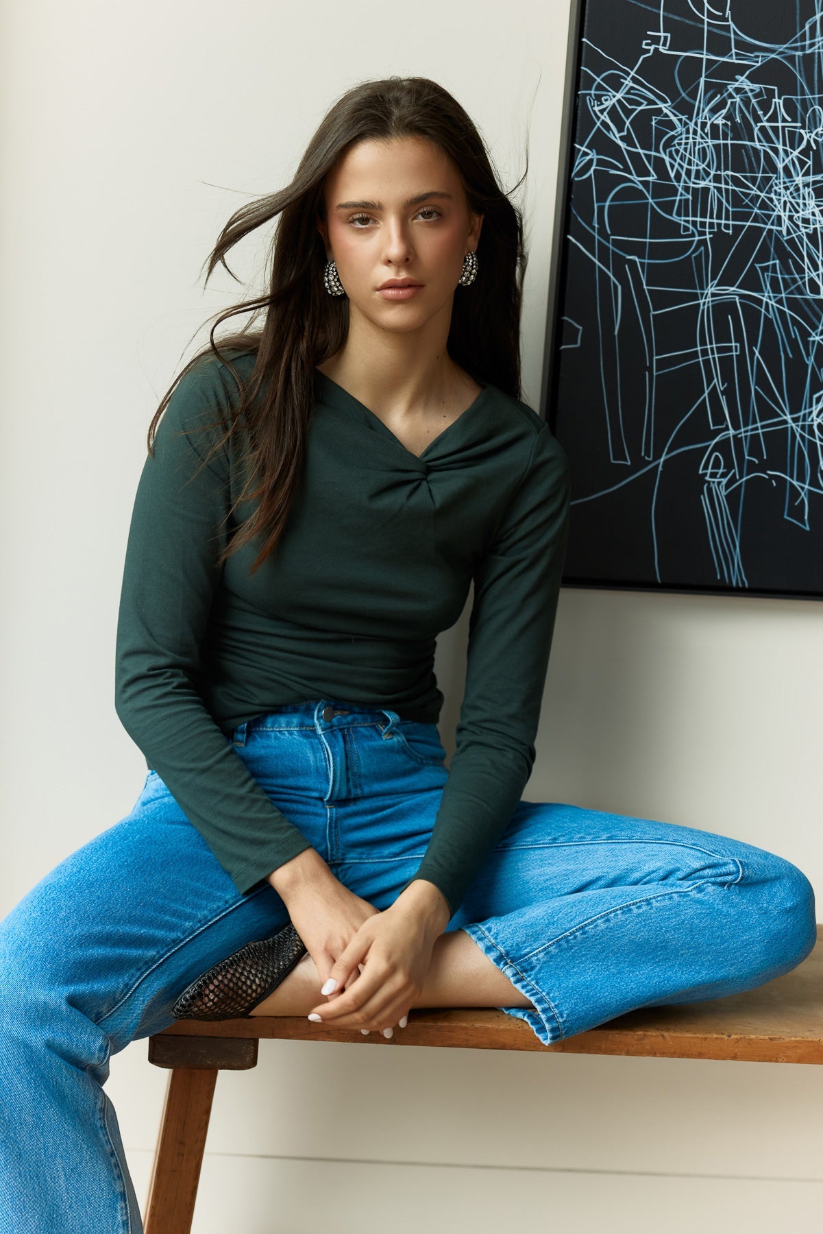 Image of a model wearing Tops. Product name - Sophia Twisted Top in Bottle Green colour by brand - Sass Clothing
