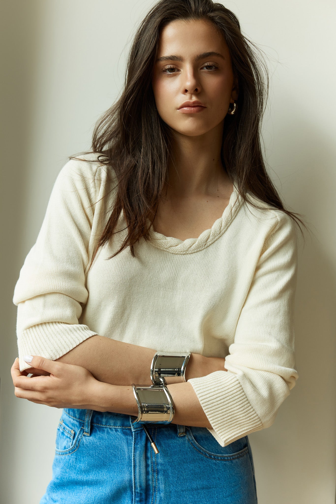 Image of a model wearing Outerwear. Product name - Roe Braided Neck Knit in Cream colour by brand - Sass Clothing