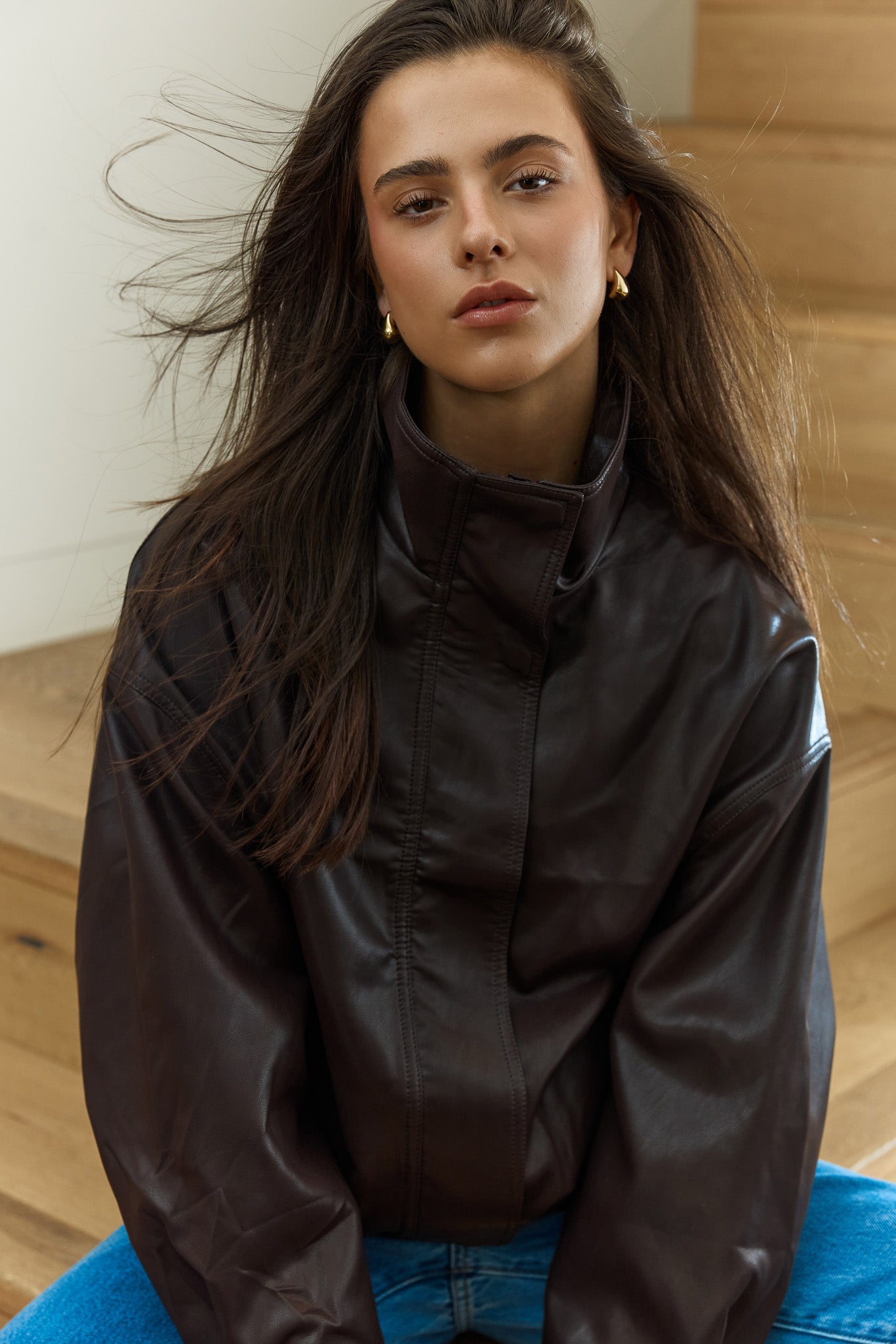 Image of a model wearing Outerwear. Product name - Jude Leather Look Bomber in Burgandy colour by brand - Sass Clothing