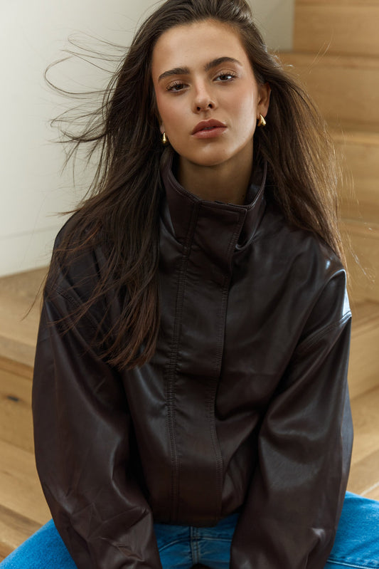 Image of a model wearing Outerwear. Product name - Jude Leather Look Bomber in Burgandy colour by brand - Sass Clothing