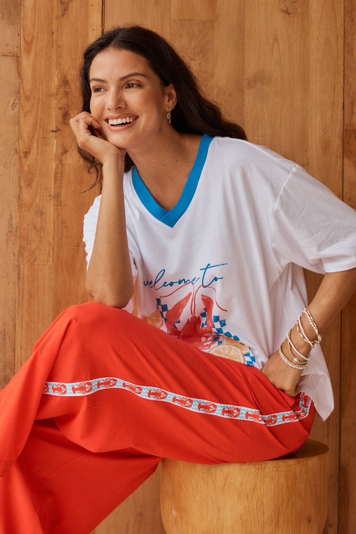 Image of a model wearing Pants. Product name - Sable Wide Leg Pant Red in Red colour by brand - Betty Basics