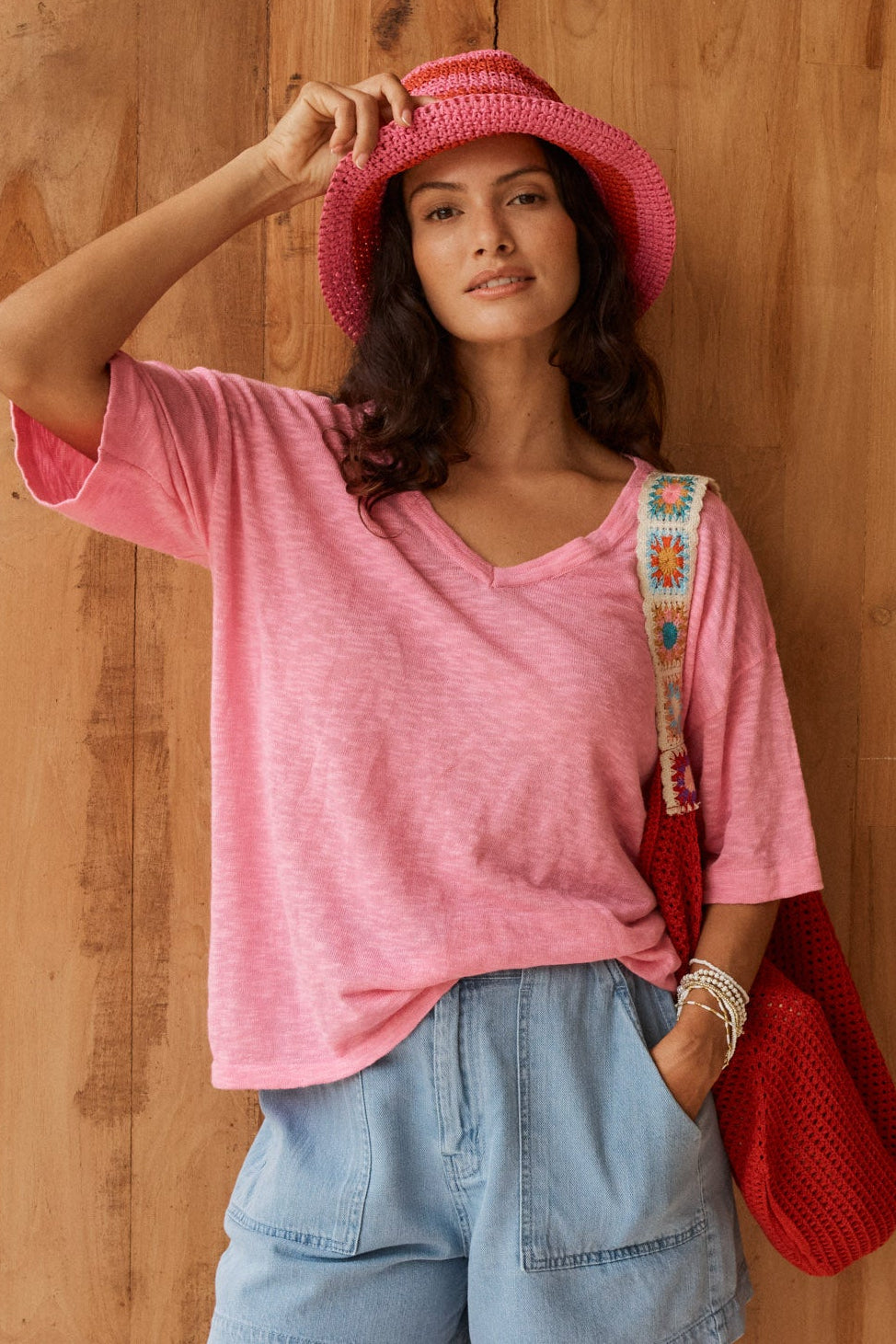 Image of a model wearing Tops. Product name - Aries V-Neck Knit Top Pink in Pink colour by brand - Betty Basics