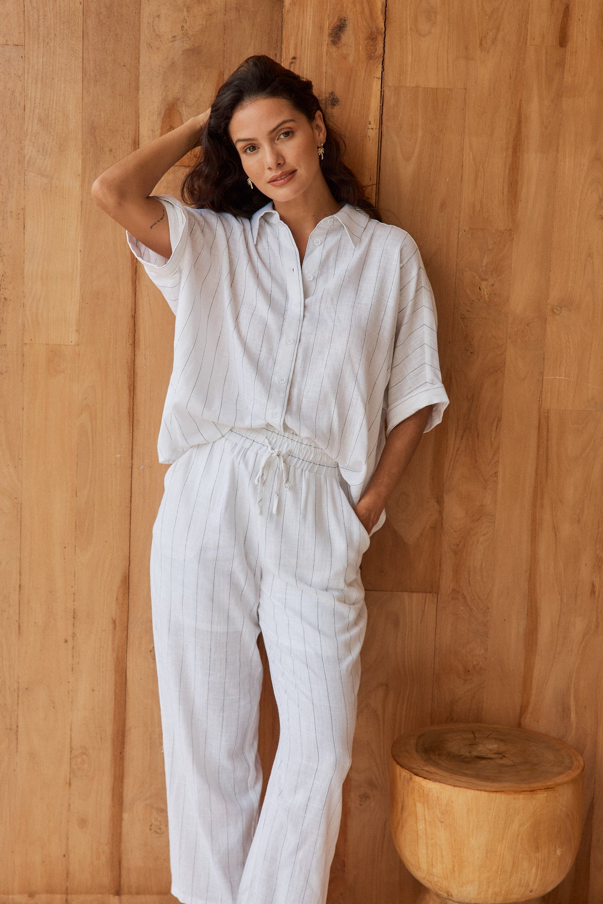 Image of a model wearing Pants. Product name - Palm Linen Blend Relax Pants White/Black Stripe in White/Black Stripe colour by brand - Betty Basics