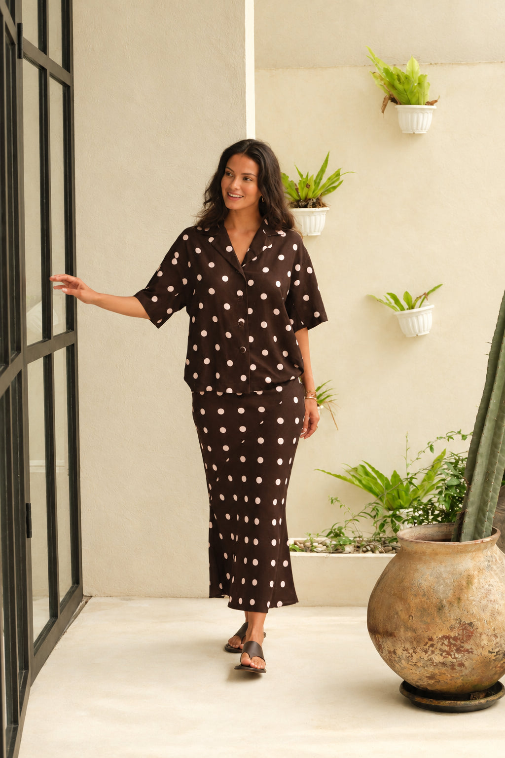 Image of a model wearing Skirts. Product name - Sable Bias Yoke Midi Skirt Pink/Choc Polka Dot in Pink/Choc Polka Dot colour by brand - Betty Basics