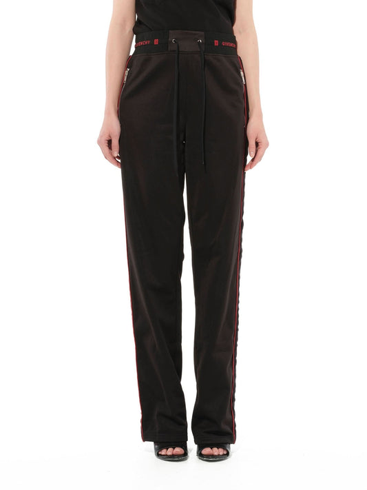 Image of a model wearing Pants. Productname: GIVENCHY Logo Track Pants in BLACK colour by brand - GIVENCHY