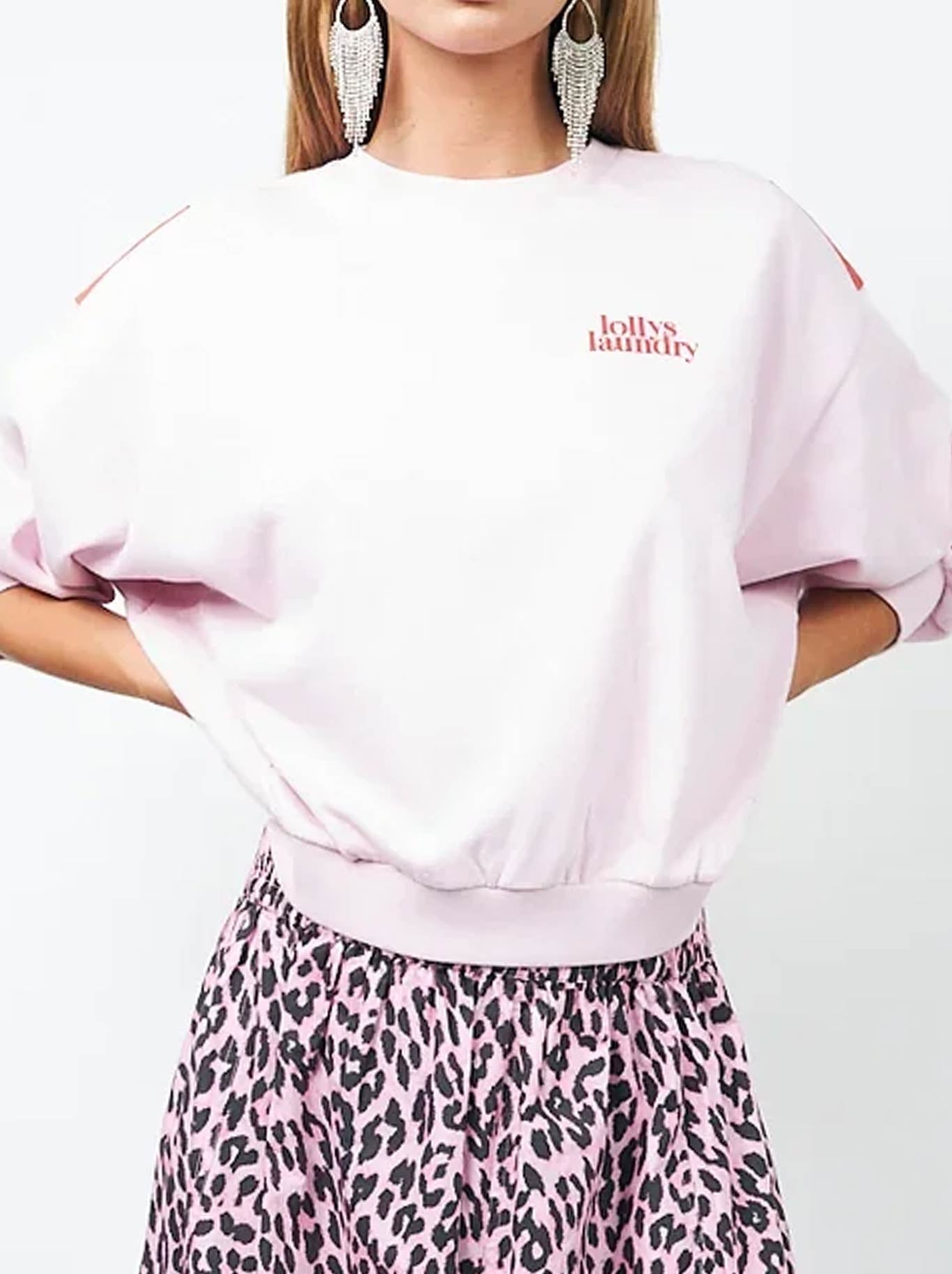 Image of a model wearing Tops. Product name - Lollys Laundry Sydney Sunset Sweatshirt in Light Pink colour by brand - Lollys Laundry