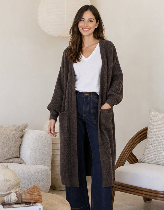 Image of a model wearing Outerwear. Product name - Longline Cable Cardi Chocolate in Chocolate colour by brand - 132 Fashion