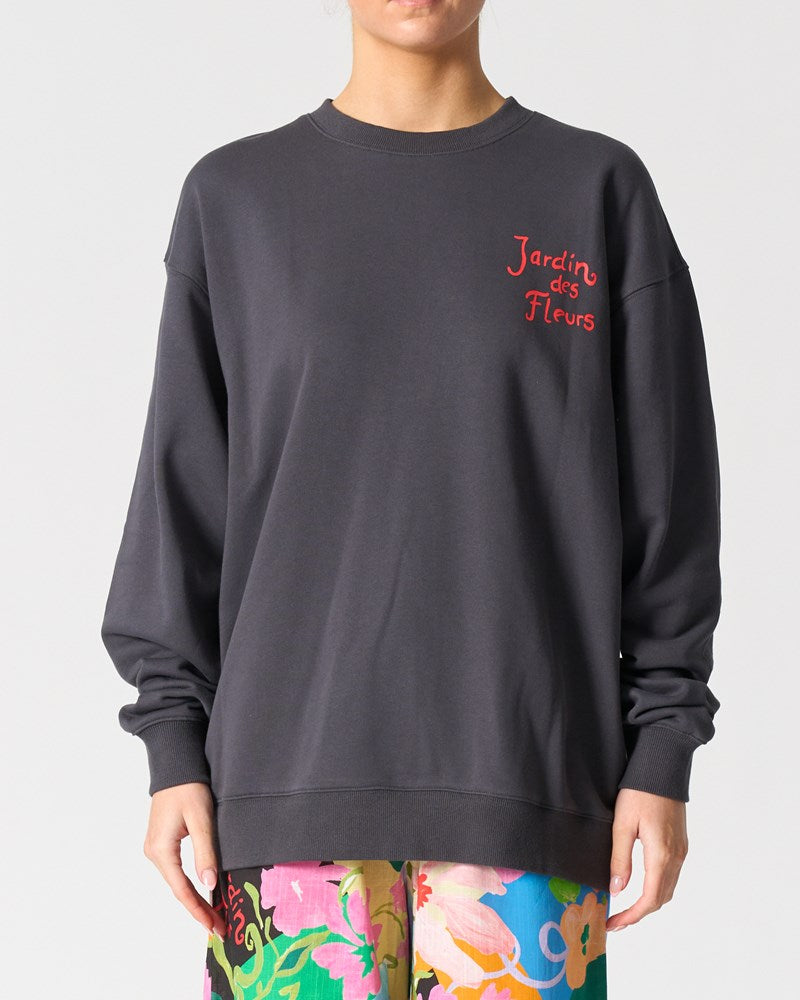 Image of a model wearing Outerwear. Product name - Los Angeles Sweatshirt in Jardin Des Fleurs colour by brand - Walnut Melbourne