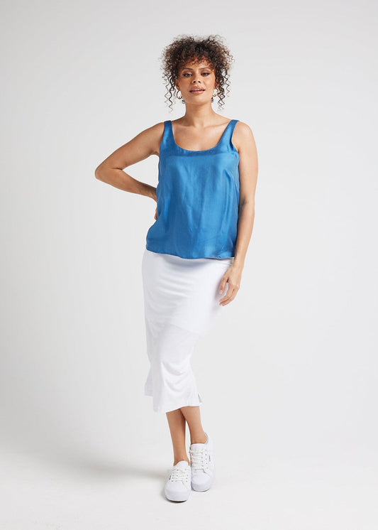 Image of a model wearing Tops. Product name - Poppy Silk Sleeveless Camisole Ocean Blue in Ocean Blue colour by brand - Lou Lou