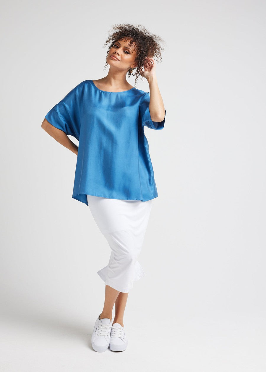 Image of a model wearing Tops. Product name - Dua Oversized Silk Top Ocean Blue in Ocean Blue colour by brand - Lou Lou