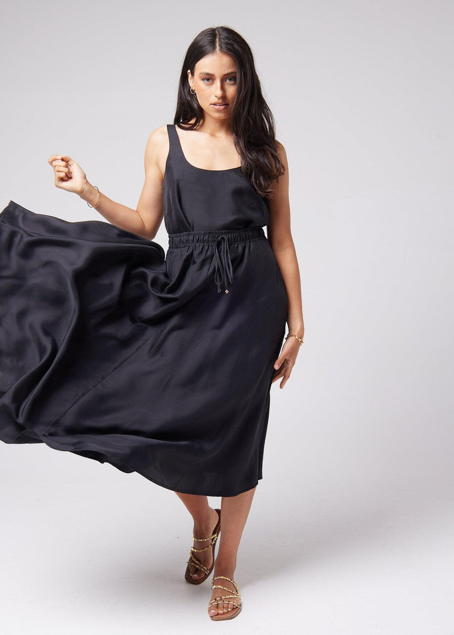 Image of a model wearing Tops. Product name - Poppy Silk Sleeveless Camisole in Black colour by brand - Lou Lou