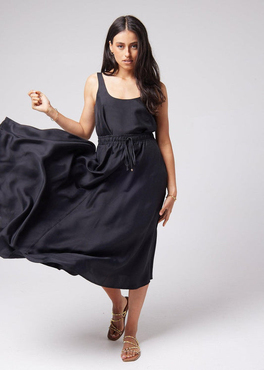 Image of a model wearing Tops. Product name - Poppy Silk Sleeveless Camisole in Black colour by brand - Lou Lou