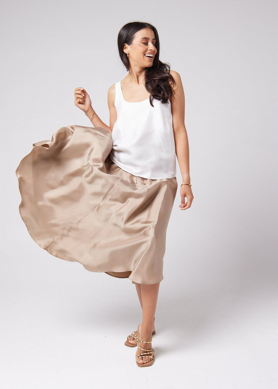 Image of a model wearing Tops. Product name - Poppy Silk Sleeveless Camisole Pearl in Pearl colour by brand - Lou Lou