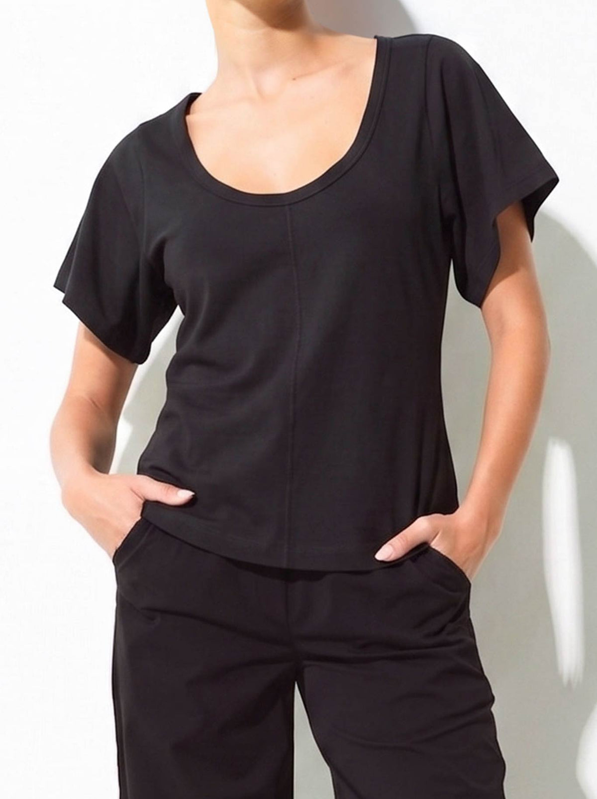 Image of a model wearing Tops. Product name - Lounge The Label Naxos Top in Black colour by brand - Lounge