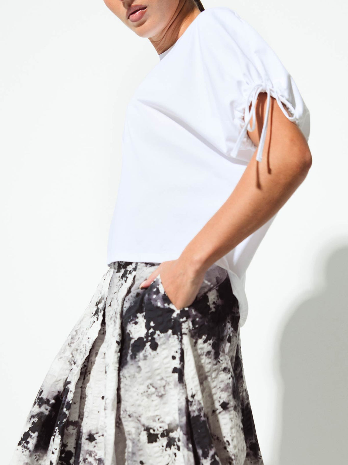Image of a model wearing Tops. Product name - Lounge The Label Daios Top in White colour by brand - Lounge