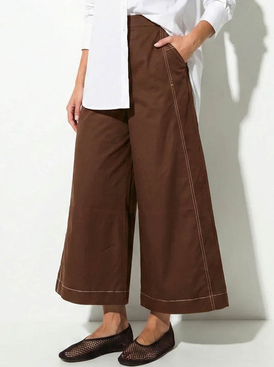 Image of a model wearing Pants. Product name - Lounge The Label Montenegro Pant in Rust White colour by brand - Lounge