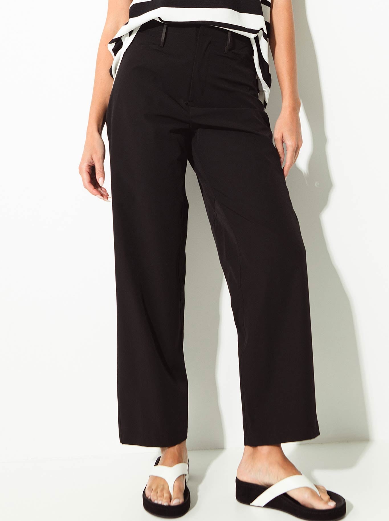 Image of a model wearing Pants. Product name - Lounge The Label Moso Pant in Black colour by brand - Lounge