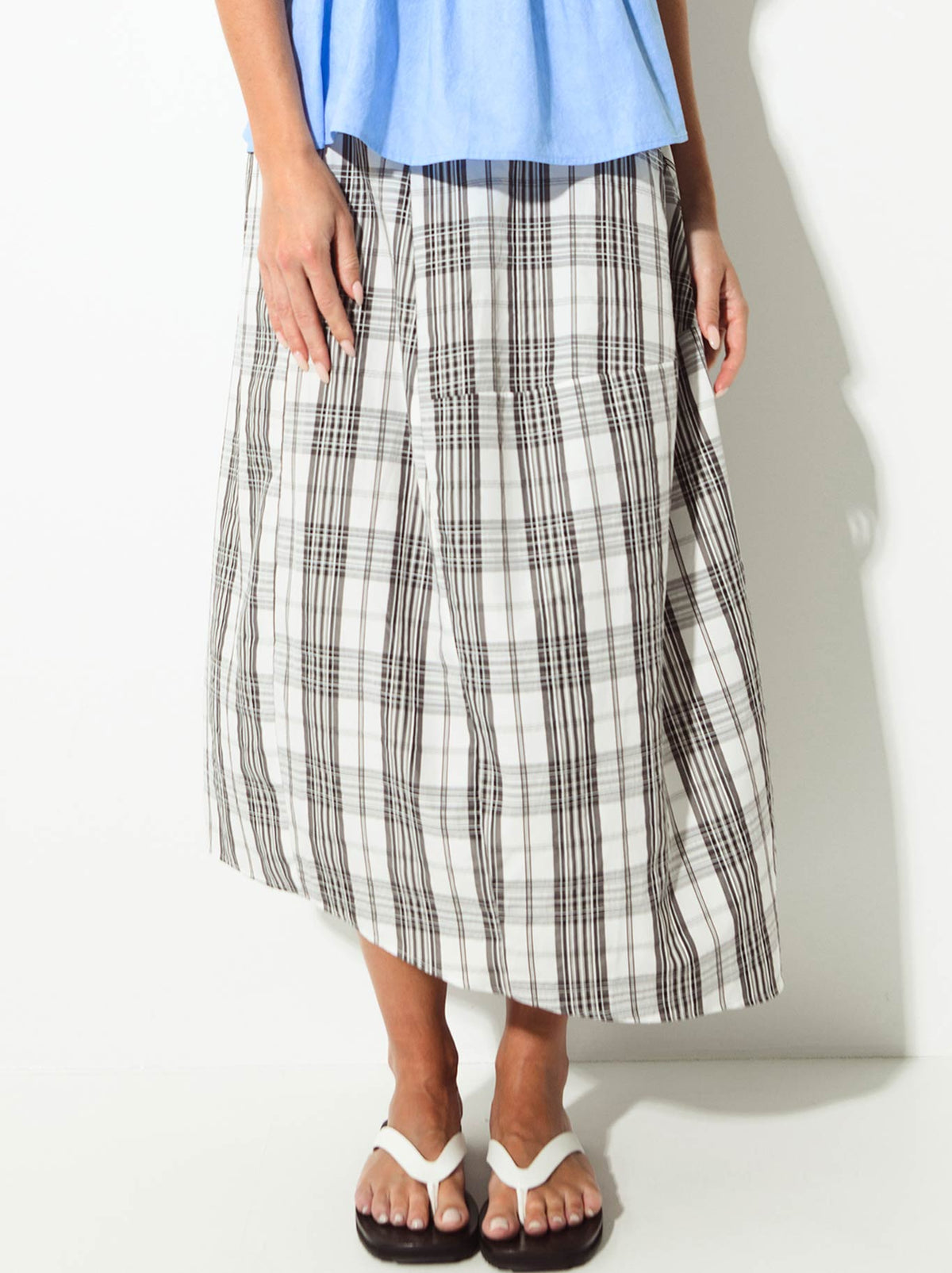 Image of a model wearing Skirts. Product name - Lounge The Label Notre Skirt in Frame colour by brand - Lounge