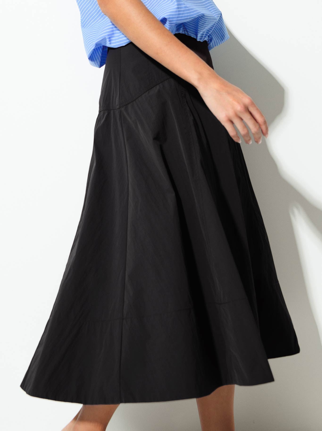Image of a model wearing Skirts. Product name - Lounge The Label Portofino Skirt in Black colour by brand - Lounge