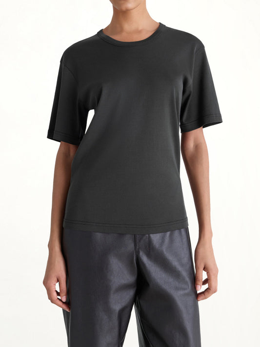 Image of a model wearing Tops. Productname: LEMAIRE Rib SS T-Shirt in Squid Ink colour by brand - LEMAIRE