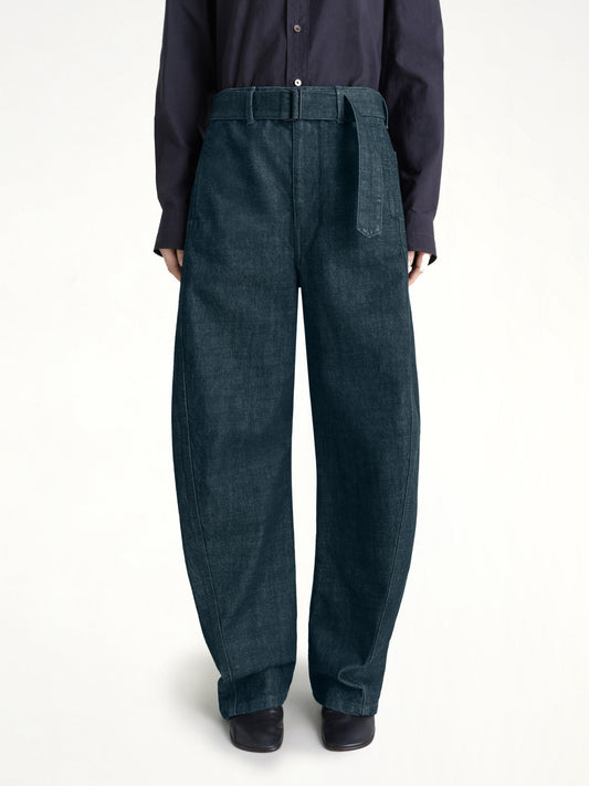 Image of a model wearing Pants. Productname: LEMAIRE Twisted Belted Pants in Denim Indigo colour by brand - LEMAIRE