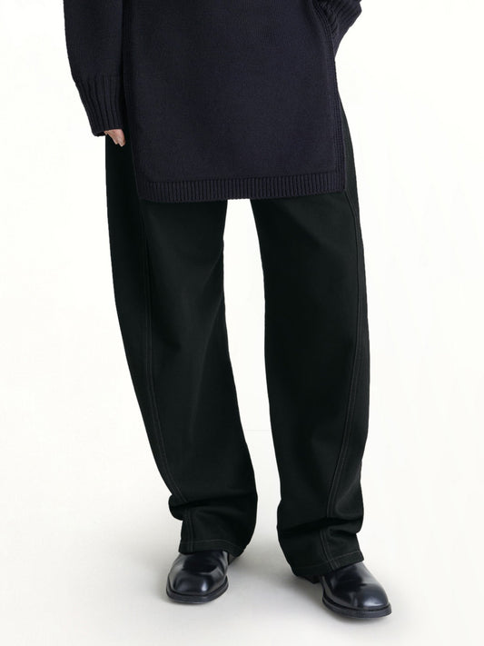 Image of a model wearing Pants. Productname: LEMAIRE Twisted Belted Pants in Black colour by brand - LEMAIRE