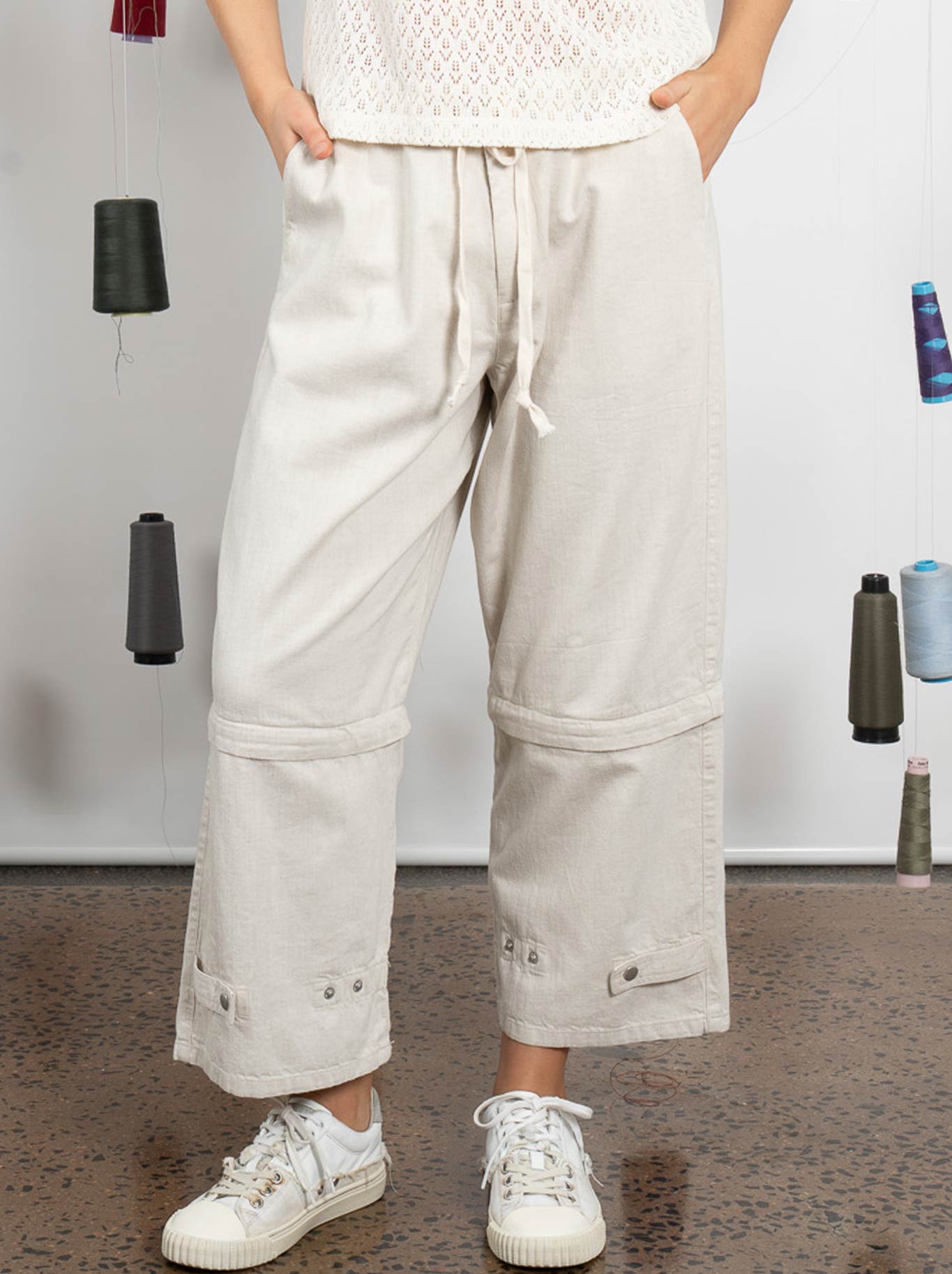 Image of a model wearing Pants. Product name - M.A Dainty Trucker Pant in Plaster colour by brand - M.A Dainty
