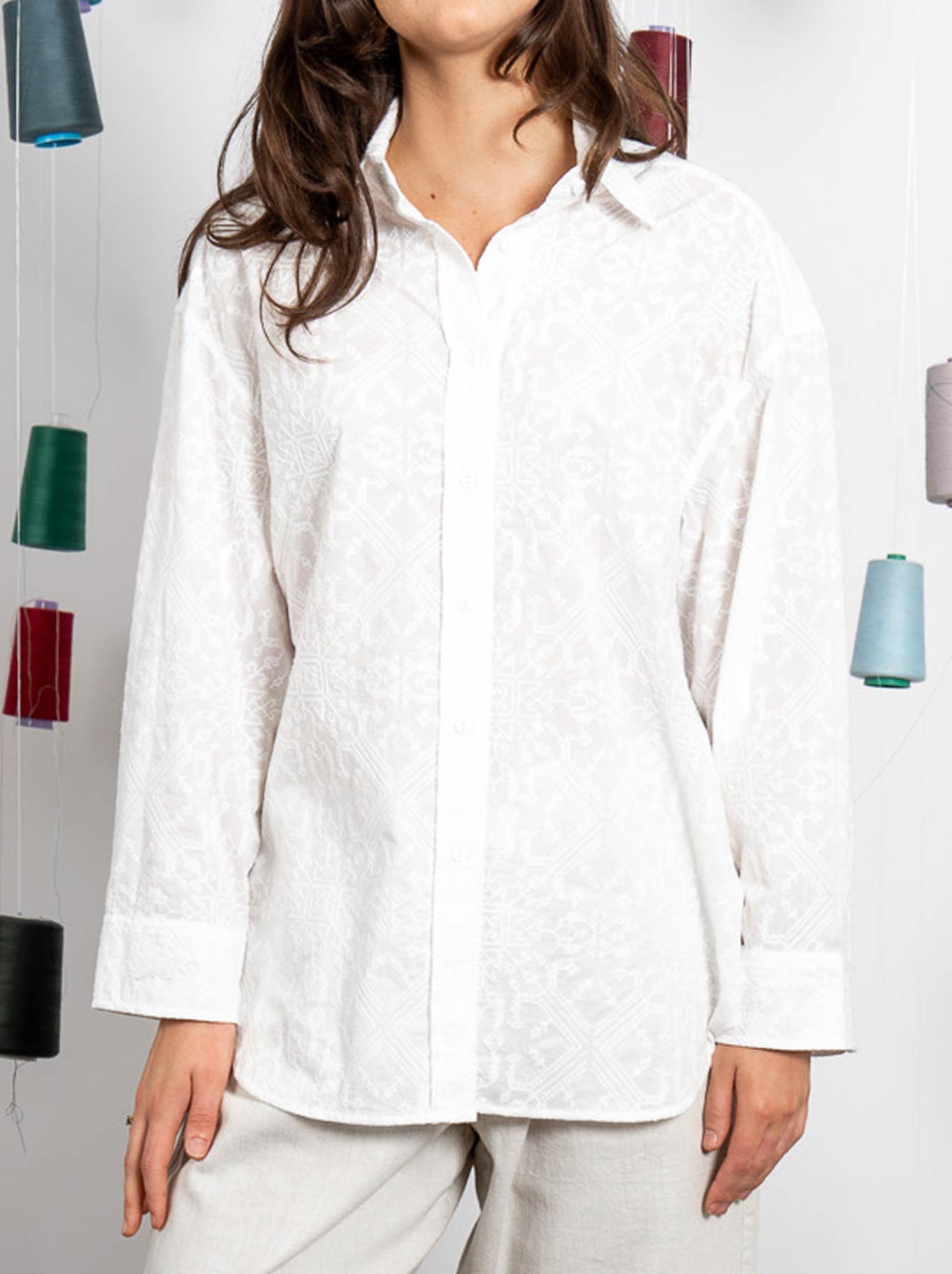 Image of a model wearing Tops. Product name - M.A Dainty Jarrah Shirt in Embroidered White colour by brand - M.A Dainty