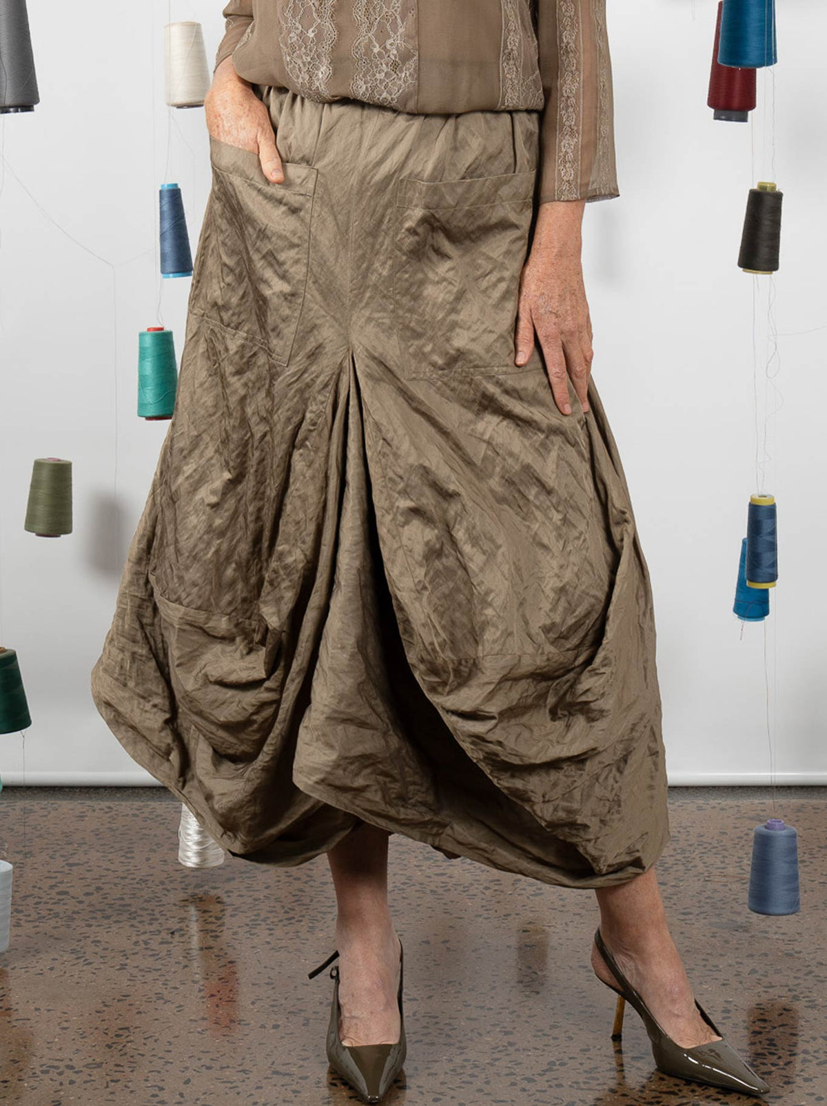Image of a model wearing Skirts. Product name - M.A Dainty Montclair Skirt in Kelp colour by brand - M.A Dainty