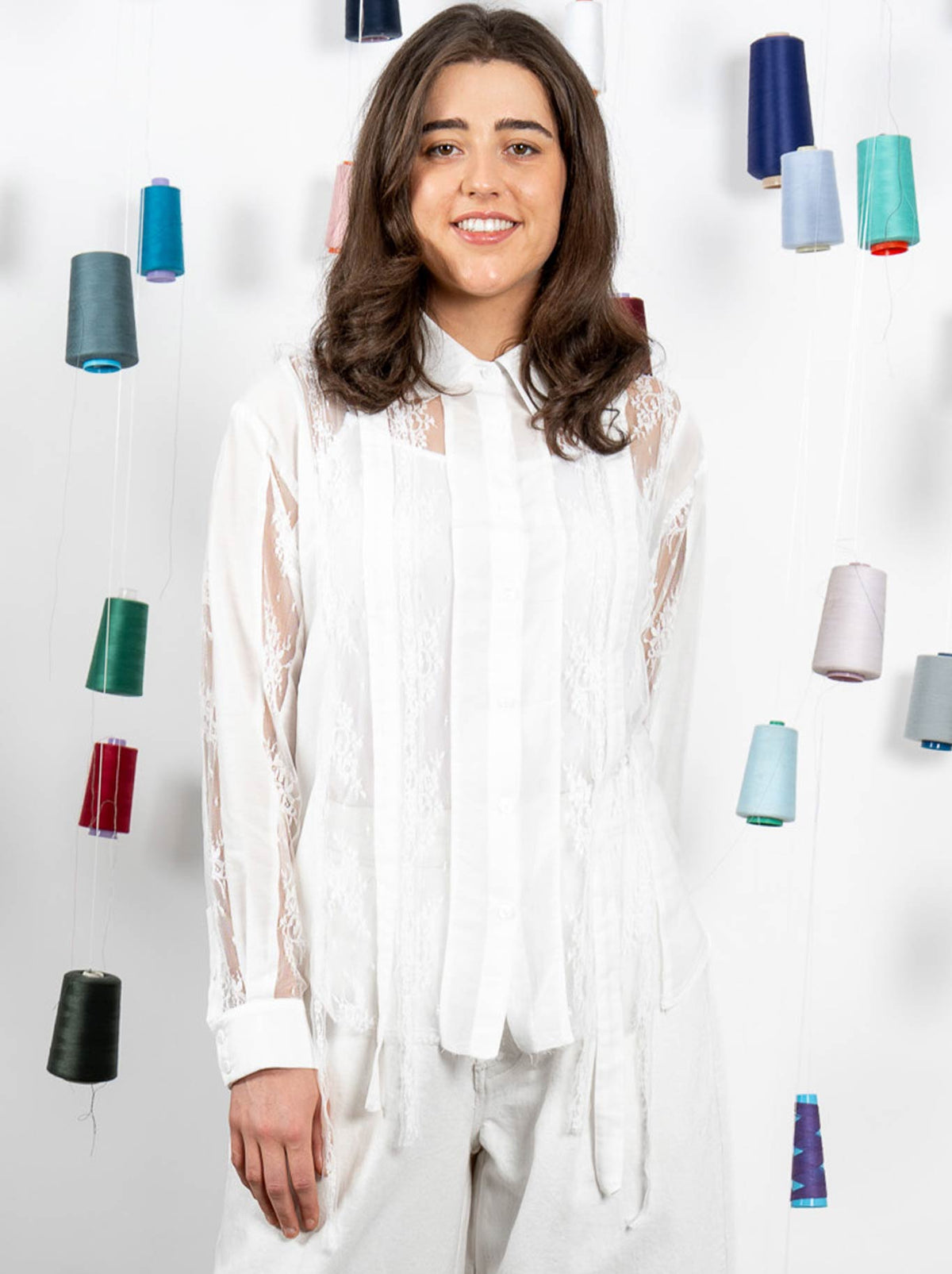 Image of a model wearing Tops. Product name - M.A Dainty Spanner Shirt in White colour by brand - M.A Dainty