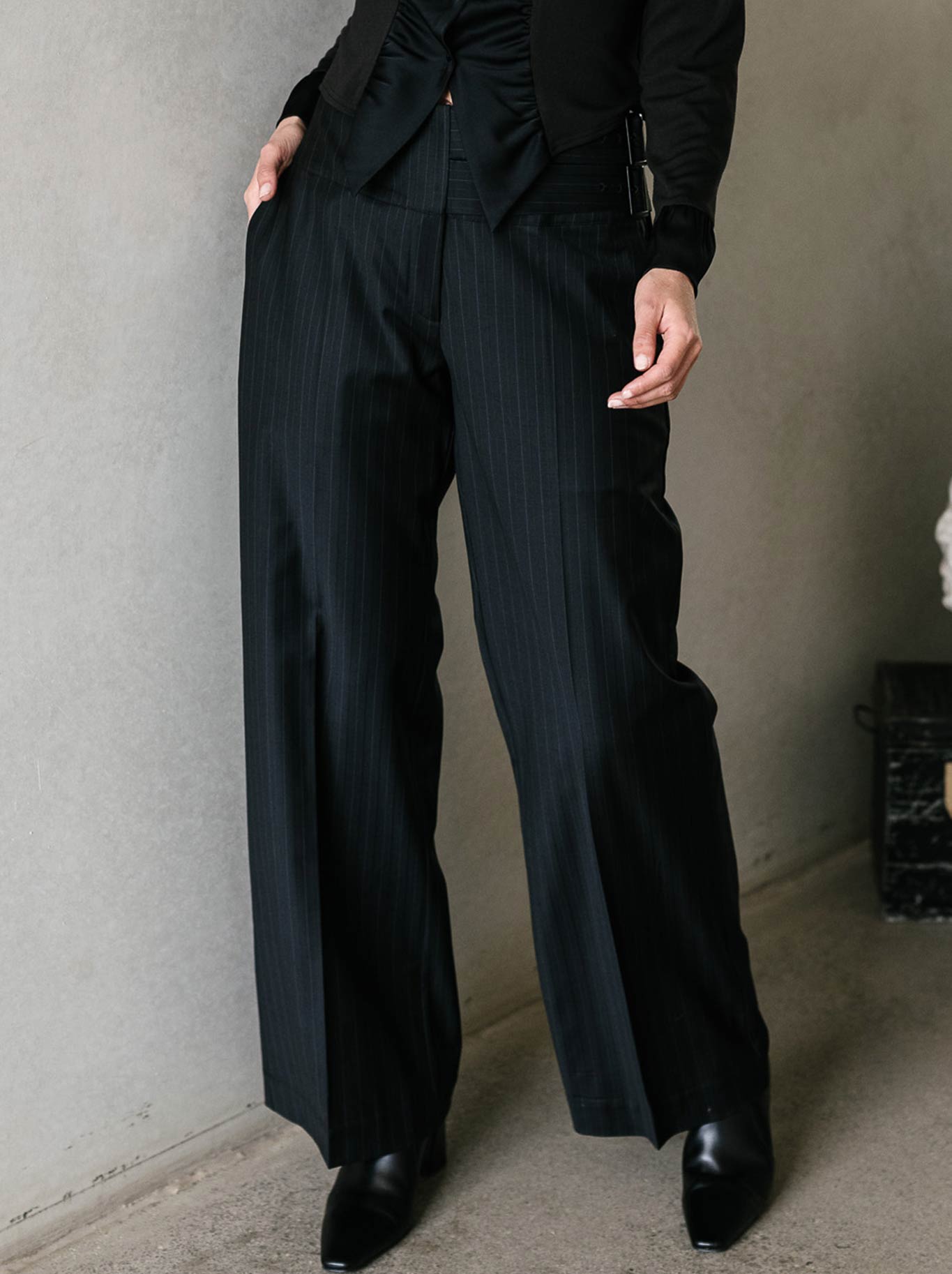 Image of a model wearing Pants. Product name - M.A Dainty Pinot Pant in Black Stripe colour by brand - M.A Dainty