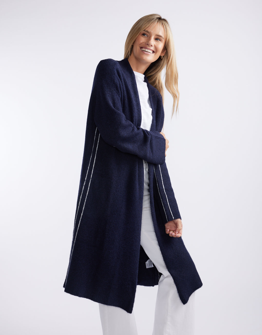 Image of a model wearing Outerwear. Product name - Montreux Wool Alpaca Longline Cardigan Navy in Navy colour by brand - White & Co.