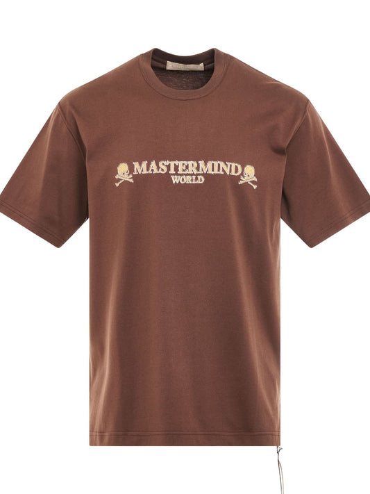 Image of a model wearing Tops. Productname: MASTERMIND Brilliant Logo T-Shirt in BROWN colour by brand - MASTERMIND