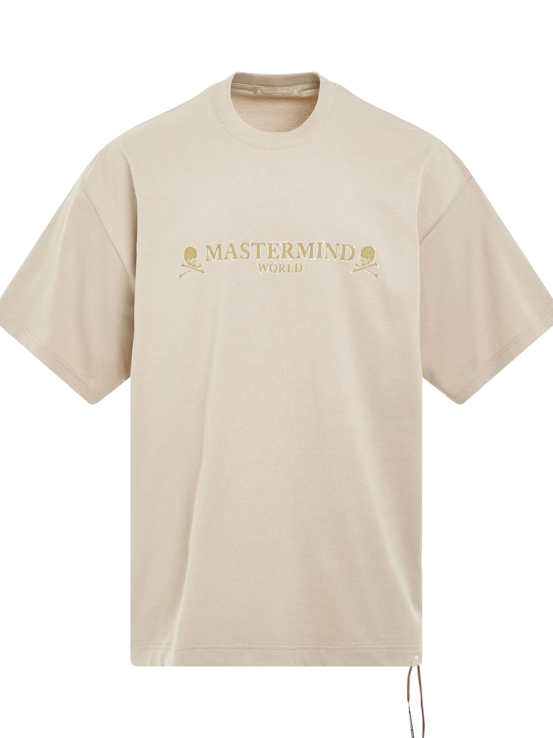 Image of a model wearing Tops. Productname: MASTERMIND Brilliant Logo Boxy Fit T-Shirt in BEIGE colour by brand - MASTERMIND