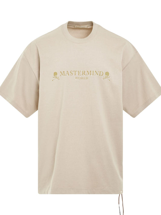 Image of a model wearing Tops. Productname: MASTERMIND Brilliant Logo Boxy Fit T-Shirt in BEIGE colour by brand - MASTERMIND