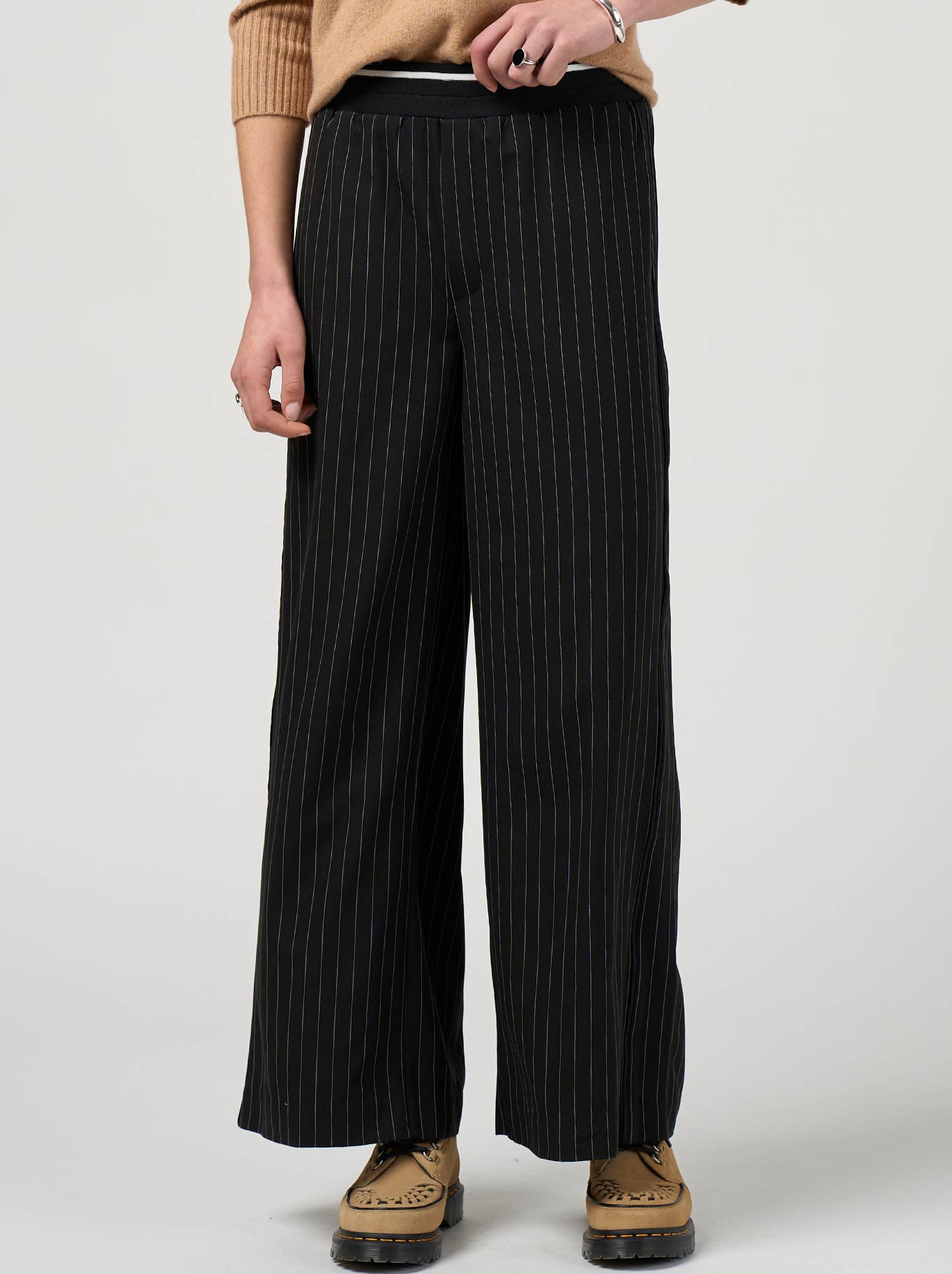 Image of a model wearing Pants. Productname: Madly Sweetly Trax Pant in Black colour by brand - Madly Sweetly
