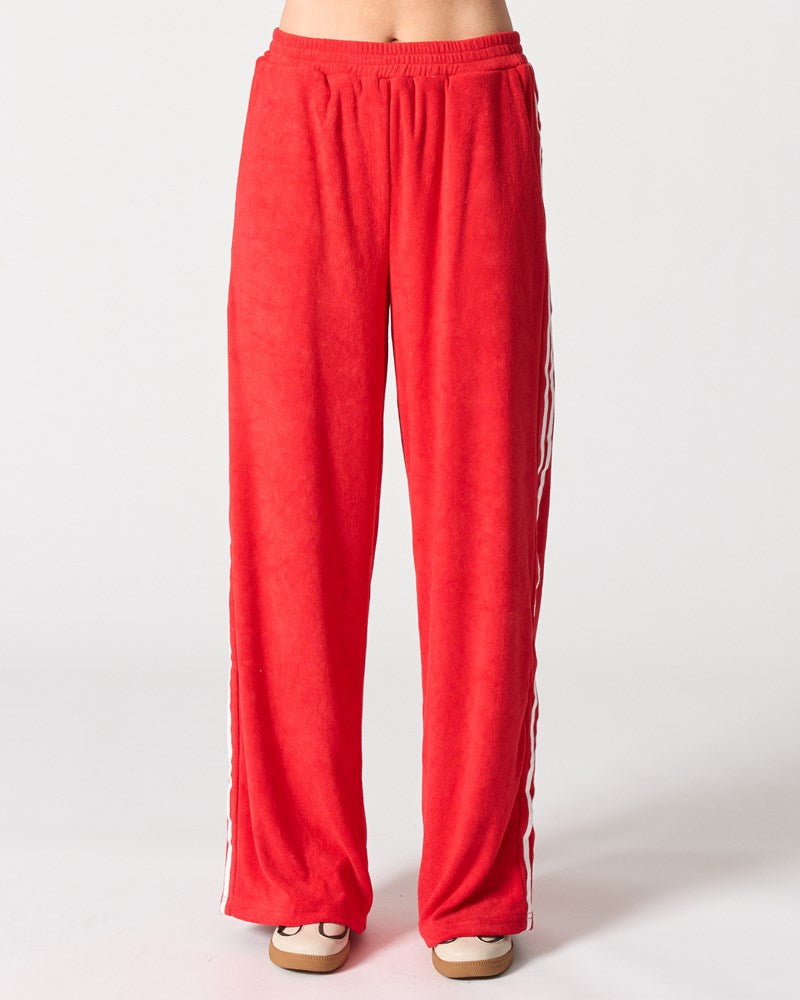 Image of a model wearing Pants. Product name - Madrid Pant in Red colour by brand - Walnut Melbourne