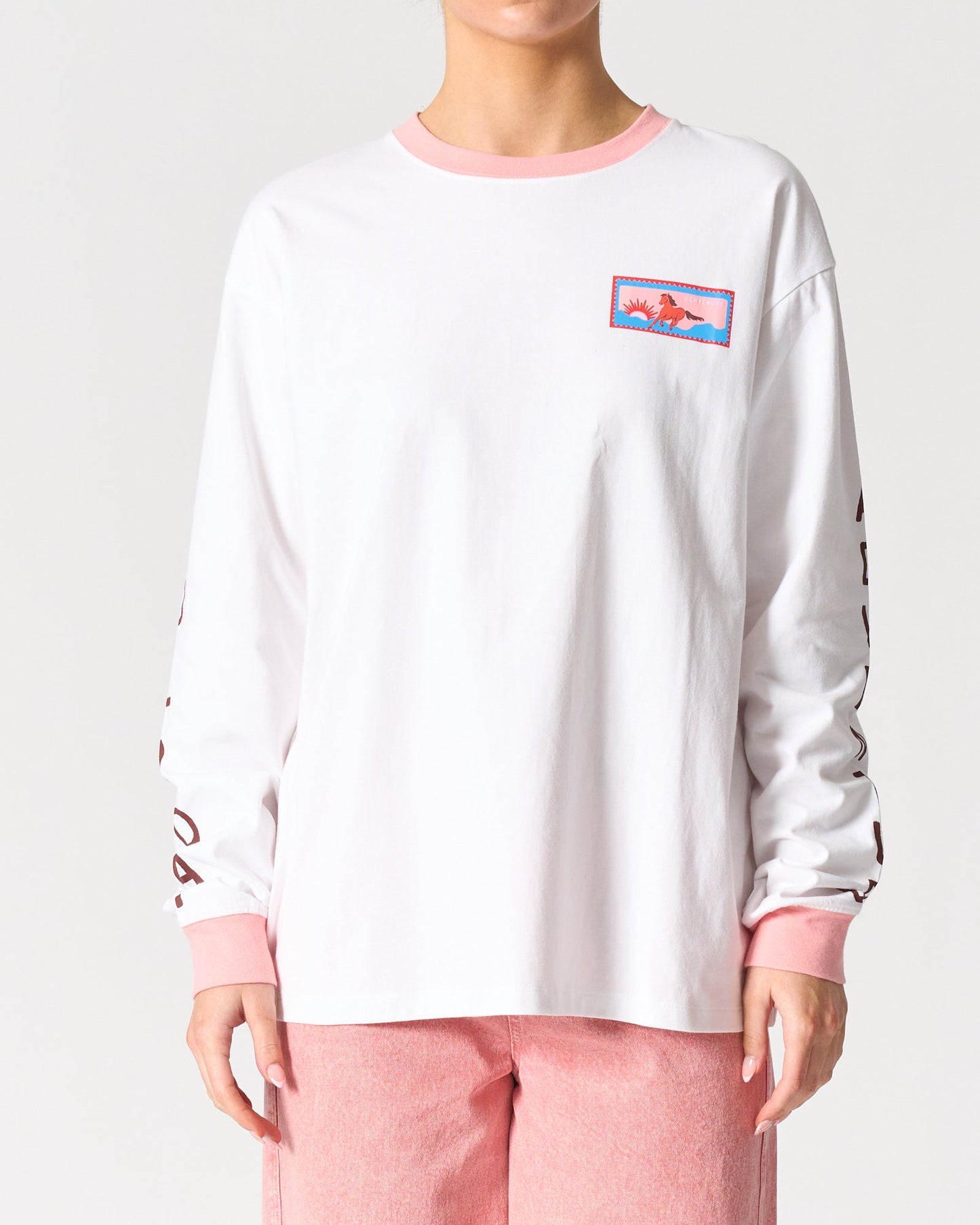 Image of a model wearing Tops. Product name - Malibu Long Sleeve Tee in Belluno Veneto colour by brand - Walnut Melbourne