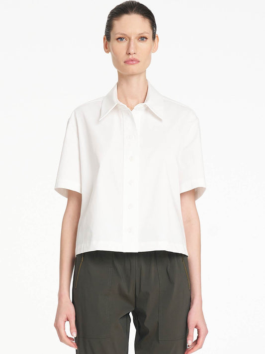 Image of a model wearing Tops. Product name - Mela Purdie Crop Shirt in White colour by brand - Mela Purdie
