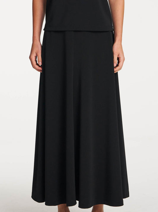 Image of a model wearing Skirts. Product name - Mela Purdie Mid Skirt in Black colour by brand - Mela Purdie