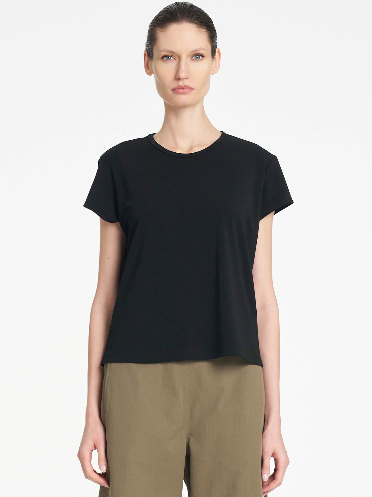 Image of a model wearing Tops. Product name - Mela Crew Cafe T in Black colour by brand - Mela Purdie