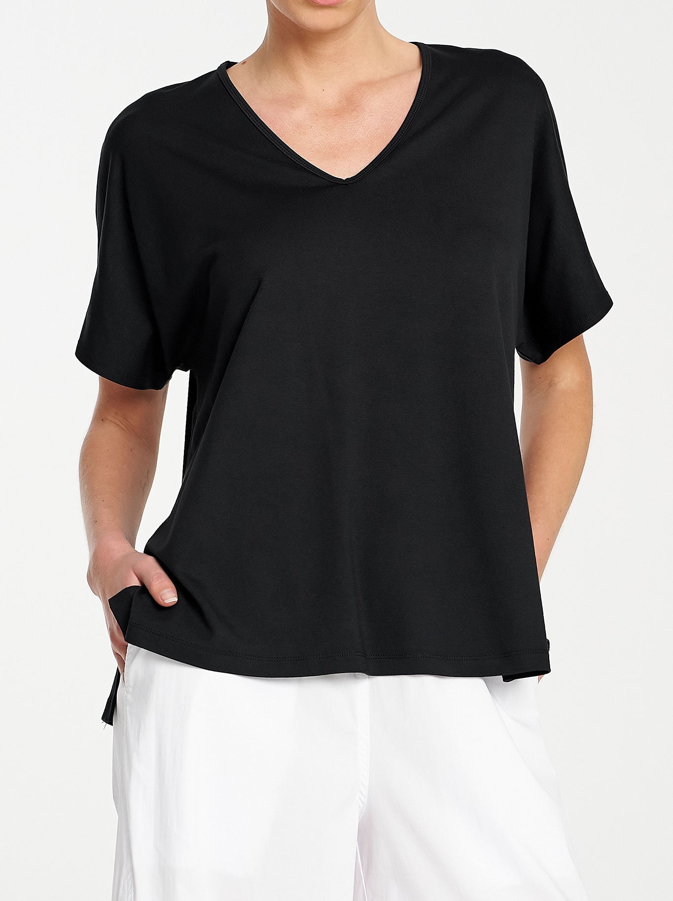 Image of a model wearing Tops. Product name - MELA PURDIE WEDGE SHELL in Black colour by brand - Mela Purdie