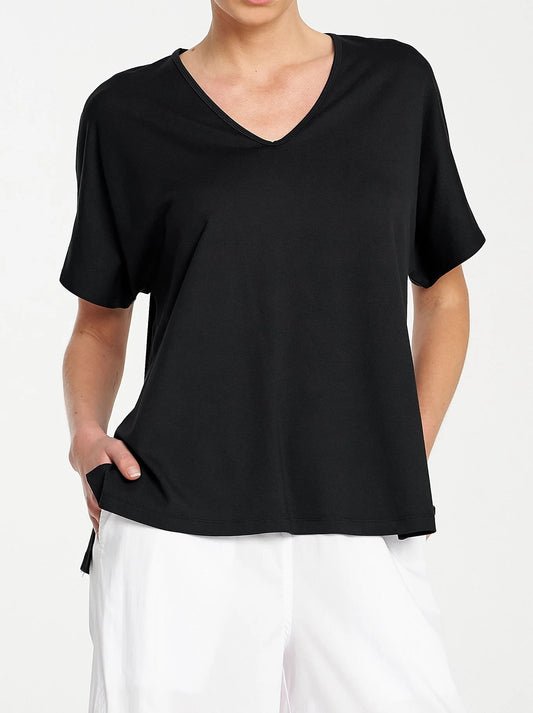 Image of a model wearing Tops. Product name - MELA PURDIE WEDGE SHELL in Black colour by brand - Mela Purdie
