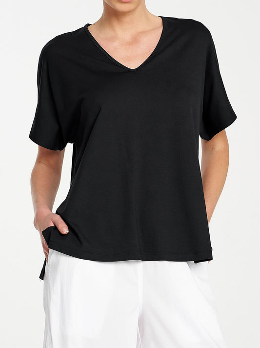 Image of a model wearing Tops. Product name - MELA PURDIE WEDGE SHELL in Black colour by brand - Mela Purdie