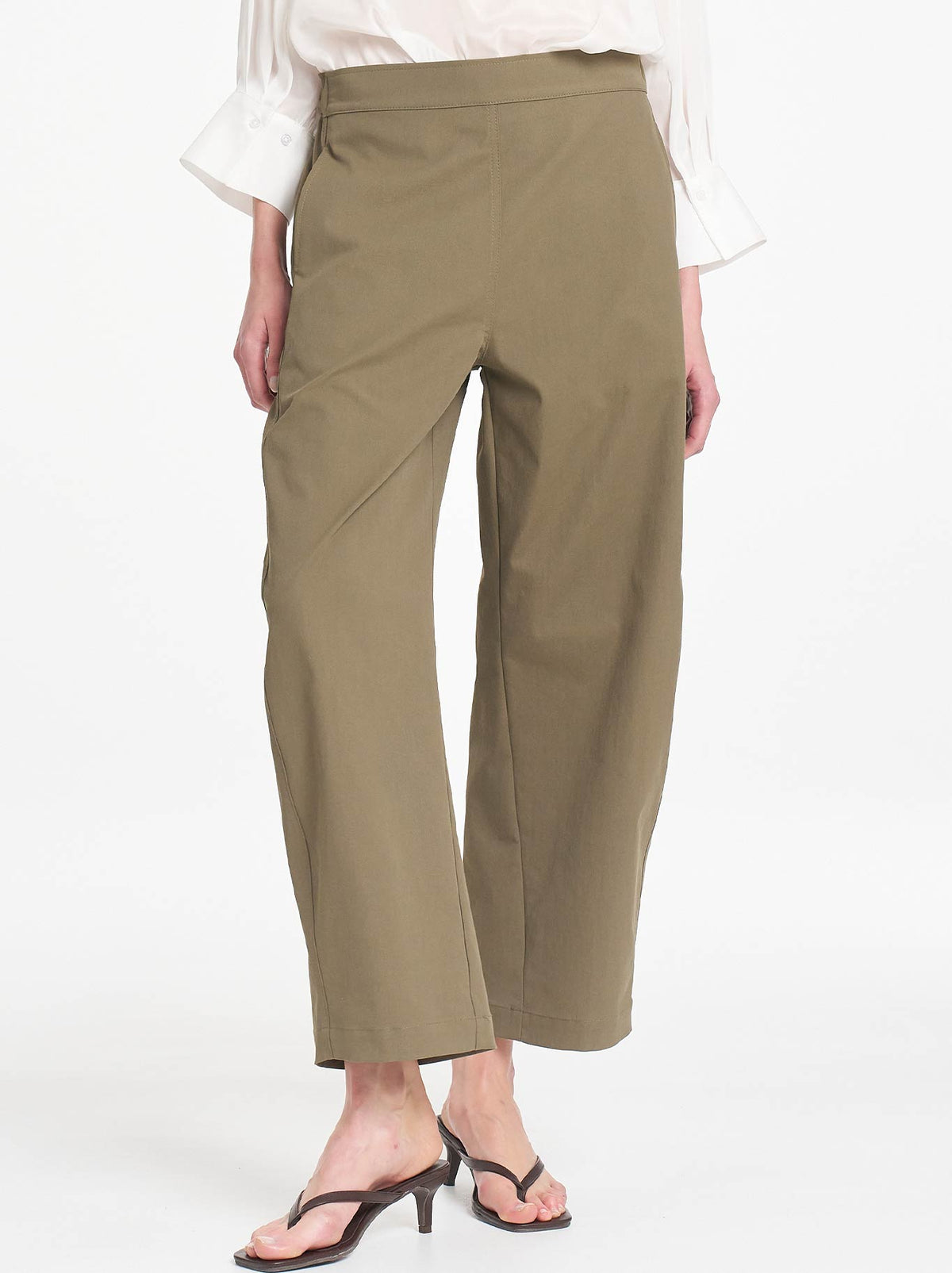 Image of a model wearing Pants. Product name - MELA PURDIE BARREL LEG PANT in Olive colour by brand - Mela Purdie